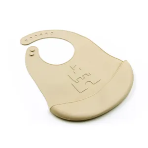 Waterproof silicone baby bib with crumb catcher pocket and cute castle design for toddlers.