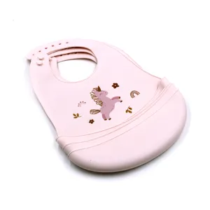 Waterproof silicone baby bib with 3d food catcher and cute unicorn print for toddlers.