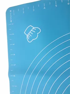 Silicone baking mat detail shot showing clear measurement scales and chef hat icon design.