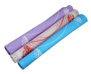 Thick silicone baking mat detail view, flexible rolled design with clear measurement scales.