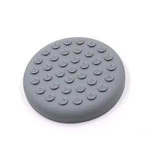 Close-up detail of small suction cups on the bottom of a grey silicone pet lick mat