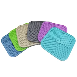 Detailed view of multi-colored silicone pet lick mats with four textured zones.