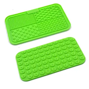 Detalle de alfombrilla de silicona verde para mascotas con texturas y ventosas traseras.