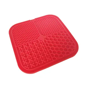 Red silicone pet lick mat slow feeder for cats and dogs with four textured feeding sections.