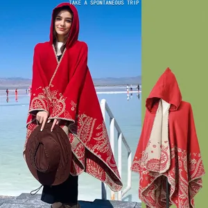 Elegant red knitted hooded poncho cloak with intricate beige paisley patterns for winter
