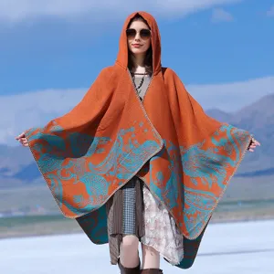 Elegant orange hooded knitted poncho with blue paisley patterns for winter travel