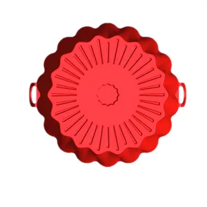 Red silicone air fryer pot closeup, flexible nonstick baking liner with two handles.