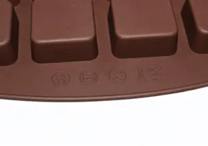 Silicone baking mold detail, brown flexible chocolate dessert mousse tray, heat resistant.
