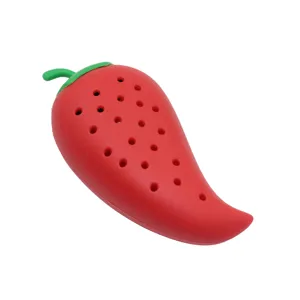 Red silicone chili pepper spice infuser detail shot, multi-hole design for kitchen cooking.