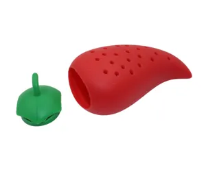 Silicone chili spice infuser detail view, red pepper shape with green lid and holes.