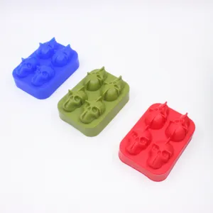 Detail view of 4-cavity skull-shaped silicone ice cube trays in blue, green, and red