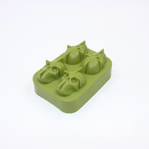 Macro detail view of a 4-cavity green silicone skull ice cube mold for party use