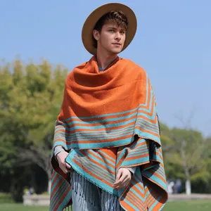Detailed view of men's orange and teal striped knitted poncho with tassels and fringe.