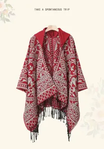 Ethnic style hooded knitted poncho shawl for women, warm winter fringe cape with geometric pattern.