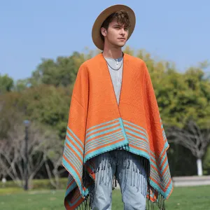 Close-up detail of men's knitted orange and teal striped poncho cloak with fringes