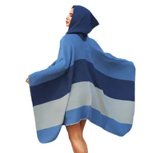 Macro view of blue striped hooded knit poncho shawl with soft draping woven fabric