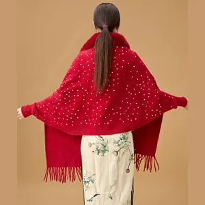 Elegant back view of red knitted shawl with shiny sequins, faux fur collar and tassels.
