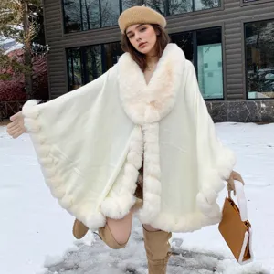 Elegant white faux fur collar cloak cape for women shown in a winter snowy outdoor scene