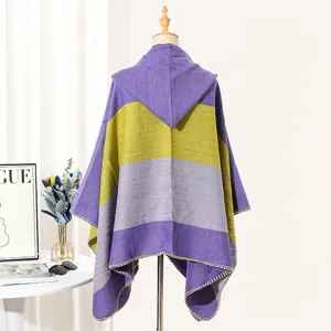 Back view of a purple and green striped woven hooded poncho cape with fringe edge
