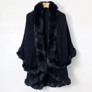 Elegant navy blue knit poncho with faux fur collar and trim for winter