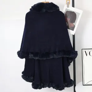 Navy blue double-layer knit cape with luxurious faux fur collar and trim detail.
