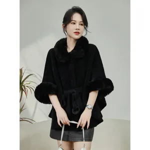 Detail view of elegant black faux mink fur cape with large collar and belted waist.