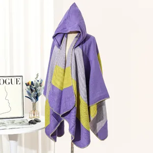 Detail of purple and yellow striped hooded woven knit poncho on mannequin