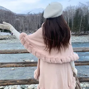 Elegant pink double-layer knit shawl with faux fur trim shown from the back in winter