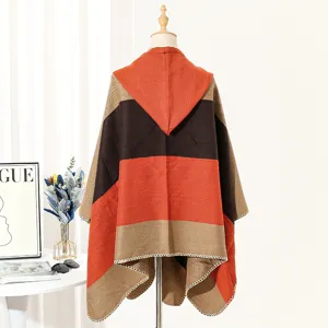 Detail showing the back view of a woven hooded knitted poncho with orange stripes.