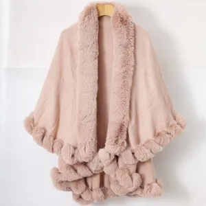 Detail view of a pink knitted shawl featuring a thick faux fur collar and soft fur trim