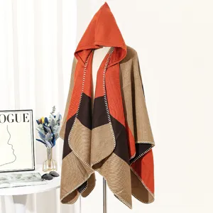 Detail showing color-block knit hooded poncho with decorative edge stitching