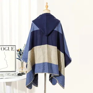 Back view detail of a cozy striped hooded knit poncho shawl for autumn and winter