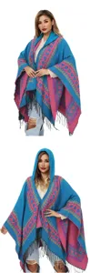 Détail du poncho en tricot bleu et rose avec capuche, motifs de cœur et longues franges