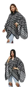 Detail view of a stylish hooded woven poncho with classic black and white patterns.