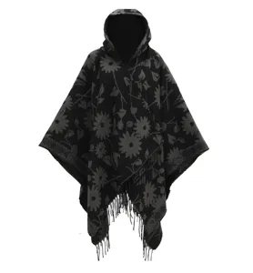 Detailed macro shot of black floral knit hooded poncho with decorative fringed hem