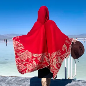 Elegant thick red knitted hooded cloak featuring ethnic paisley pattern for winter travel