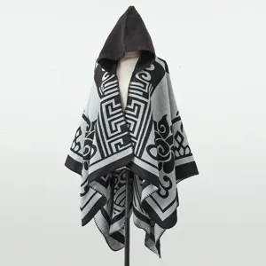 Detailansicht eines Winter-Strickponchos mit Kapuze und auffälligen geometrischen Mustern.