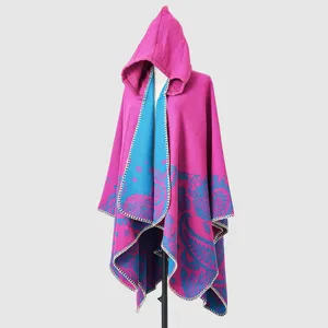Detailed view of magenta and blue hooded knit shawl with paisley pattern