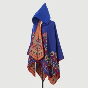 Bohemian hooded knitted poncho with intricate floral jacquard pattern on mannequin