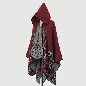 Side view of a burgundy knitted hooded cloak with intricate grey jacquard patterns.