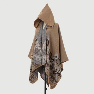 Detailed macro view of a women's hooded knitted poncho with vintage jacquard patterns