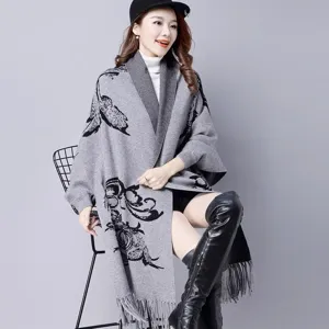 Stylish grey knitted shawl poncho for women featuring black floral patterns and fringe