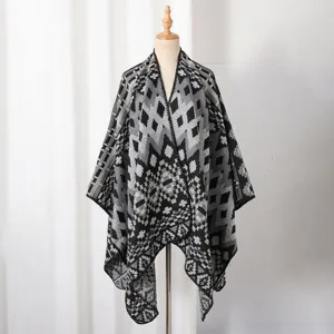Detail of a knit men's shawl poncho featuring a black and grey geometric diamond pattern.
