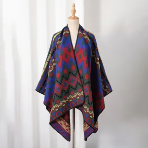 Detailed view of a warm knit geometric pattern poncho displayed on a mannequin stand