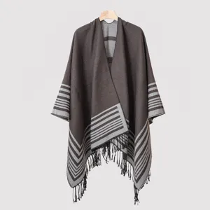 Close-up of the front design and tassels of a men's striped knitted poncho shawl.