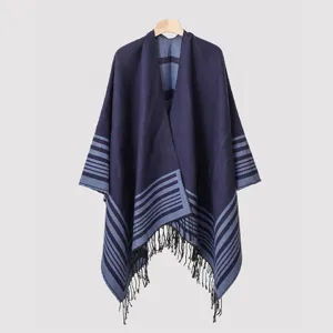 Close-up of a navy blue striped knitted shawl with decorative tassels at the hem