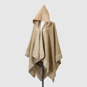 Close-up detail of a camel hooded knitted shawl featuring an elegant Greek key border pattern
