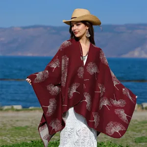 Detailaufnahme eines burgunderfarbenen Strickponchos mit weißem Ginkgo-Jacquard.