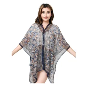 Model wearing a long paisley print chiffon bikini cover-up for beach sun protection