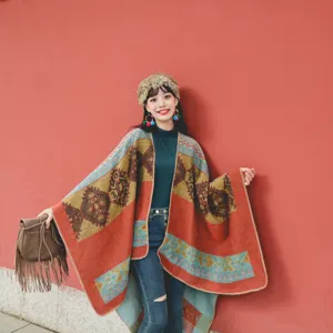 Ethnic style thick woven shawl with colorful geometric patterns on a red wall